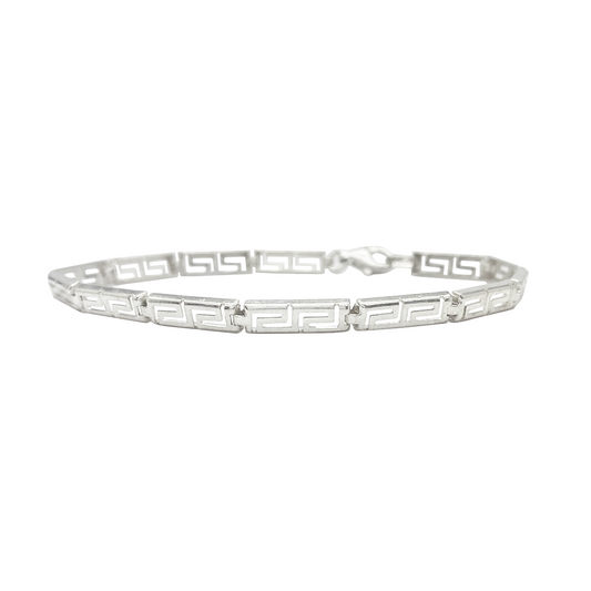 Silver bracelet with a Greek key pattern on a white background.