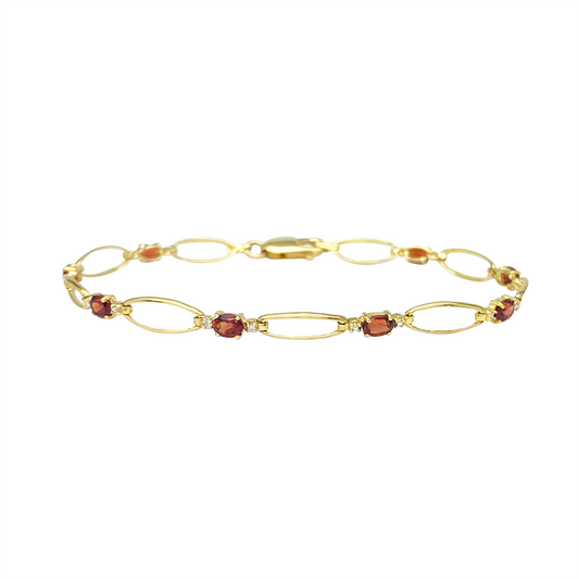 Yellow gold bracelet with garnet and diamond accents on a white background.