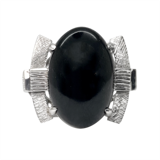 Silver ring with a black oval gemstone on a white background.