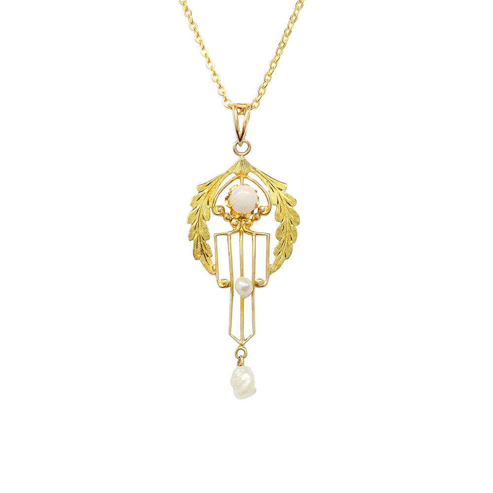 Gold necklace with an opal and pearl pendant on a white background.