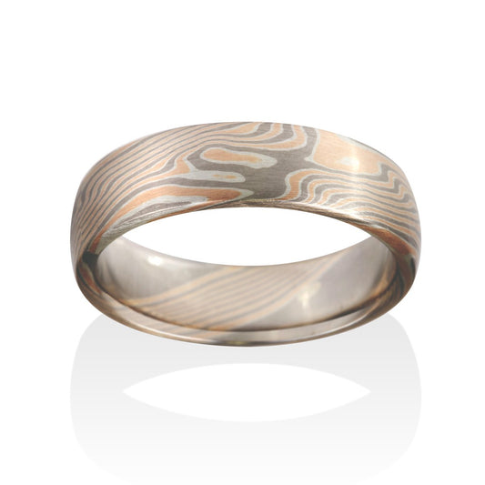 Damascus steel band ring on a white background