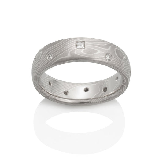 Damascus steel with diamond accents band ring on a white background