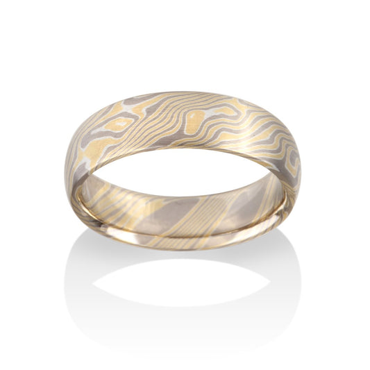 Damascus steel band ring on a white background