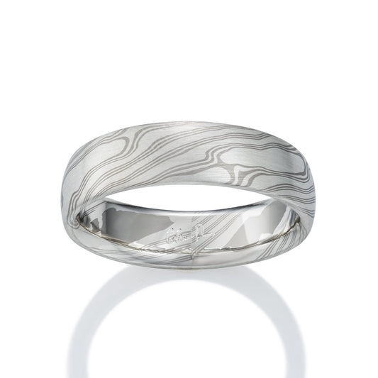 Damascus steel band ring on a white background