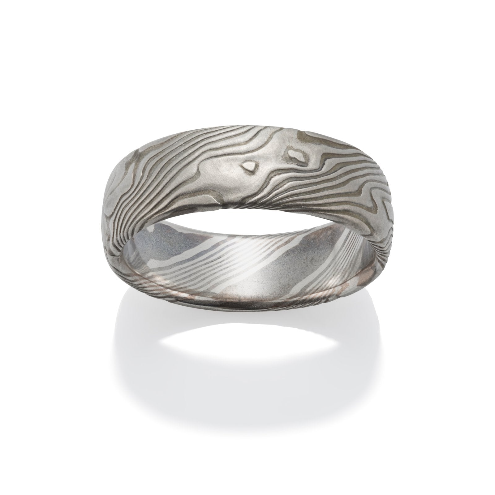 Damascus steel band ring on a white background