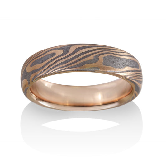 Damascus steel band ring on a white background