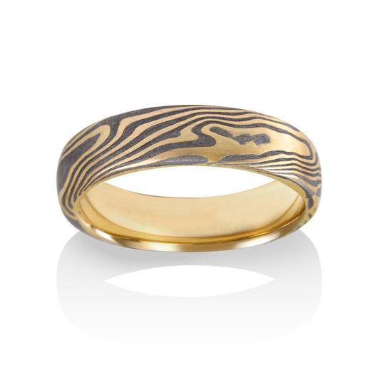 Damascus steel band ring on a white background