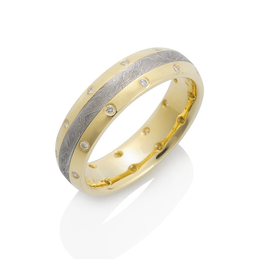 Yellow gold ring with a meteorite inlay and diamond accents on a white background.