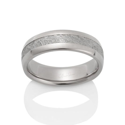 Silver ring with a meteorite inlay on a white background.