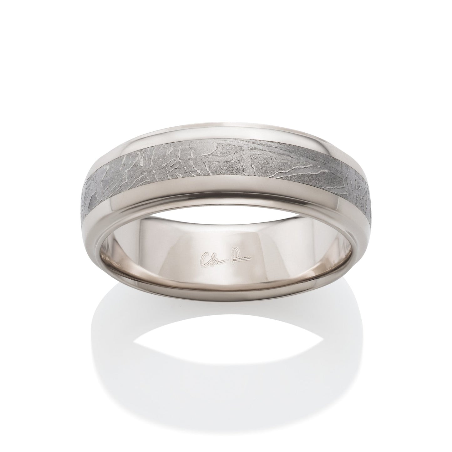 Silver ring with a meteorite inlay on a white background.