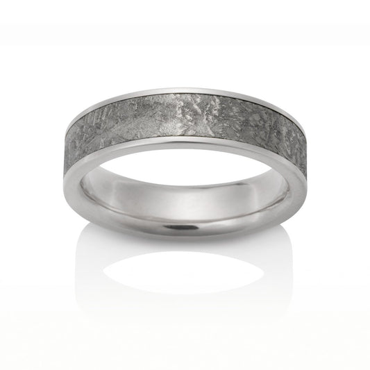 White gold ring with a meteorite inlay on a white background.