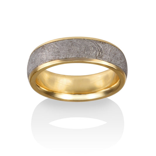 Gold ring with a meteorite inlay on a white background.