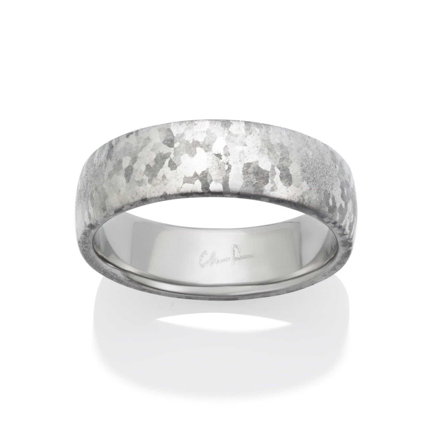 Silver ring with meteorite-like surface on a white background.