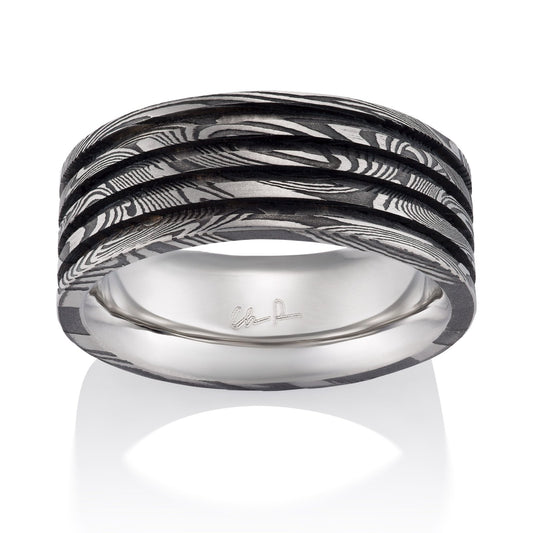 Silver ring with Damascus steel band on a white background on a white background