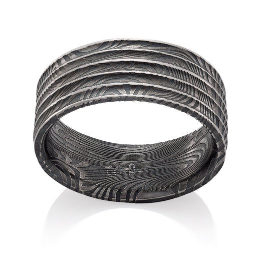 Damascus steel pattern band ring on a white background.