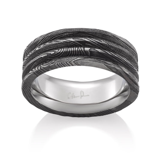 Damascus steel pattern band ring on a white background.