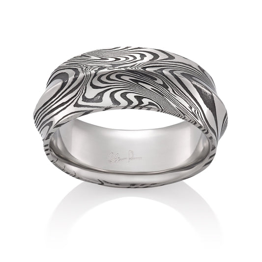 Damascus steel pattern band ring on a white background.