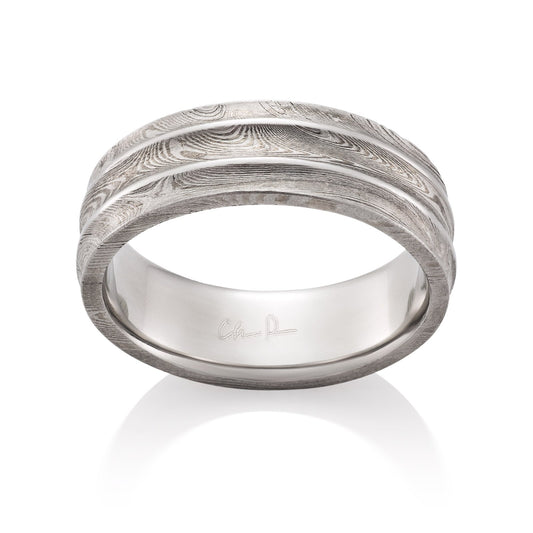 Damascus steel pattern band ring on a white background.