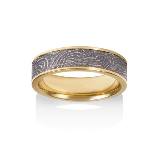 Two-tone gold ring with a textured, patterned center on a white background.