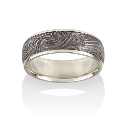 Silver with a textured, patterned center on a white background.