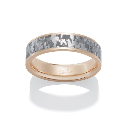 Rose gold ring with a meteorite inlay on a white background.