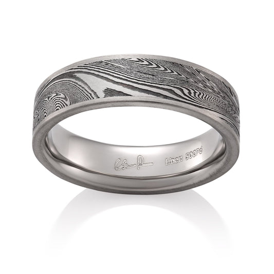 Silver ring with a Damascus steel pattern on a white background.