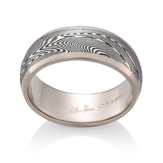 Silver ring with a Damascus steel pattern on a white background.