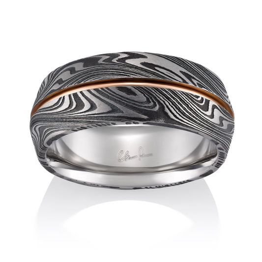 Two-tone ring with a Damascus steel pattern and a rose gold inlay on a white background