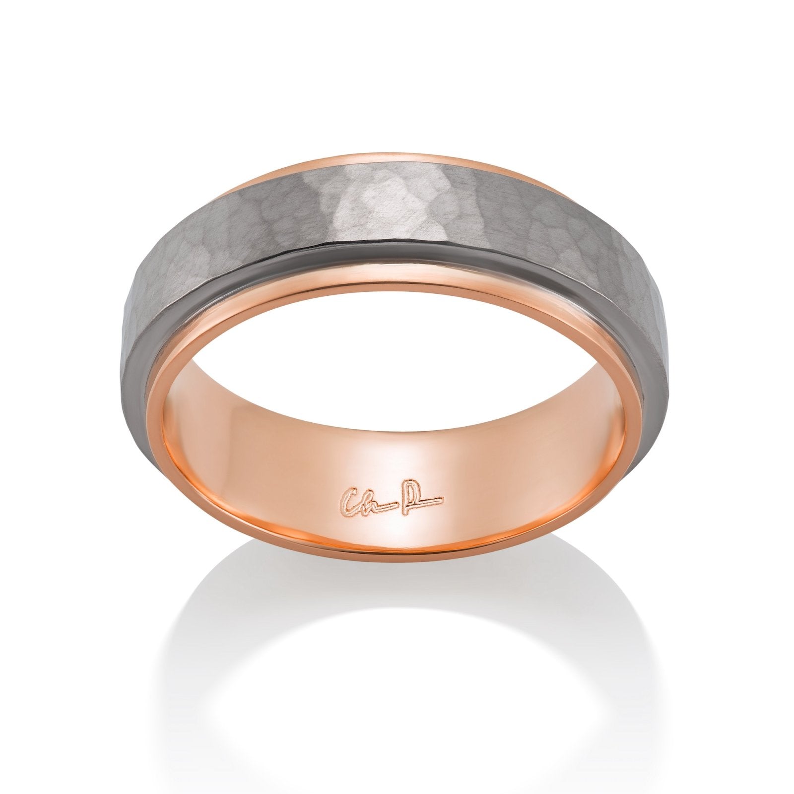 Rose gold ring with a textured, hammered surface on a white background.