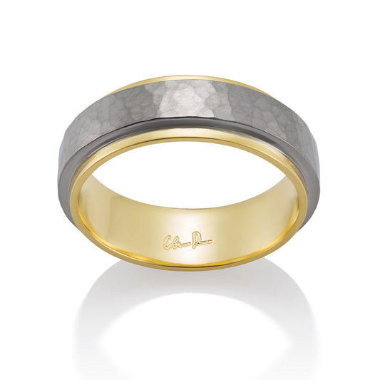 Yellow gold ring with a textured, hammered surface on a white background.