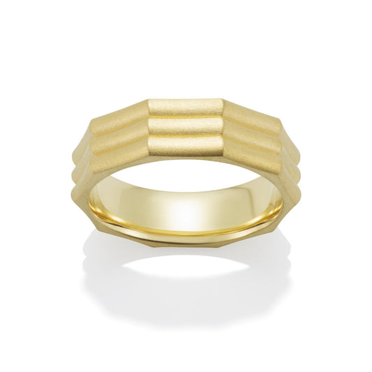 Yellow gold band ring on a white background