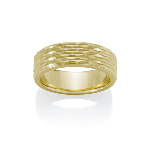 Yellow gold ring with a textured, geometric pattern on a white background.