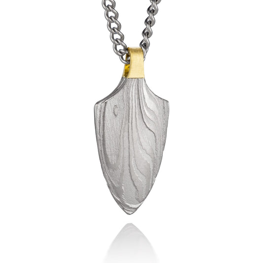 Silver shield-shaped Damascus necklace on a white background. 