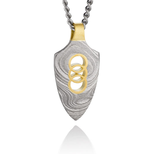 Silver shield-shaped Damascus necklace on a white background. 