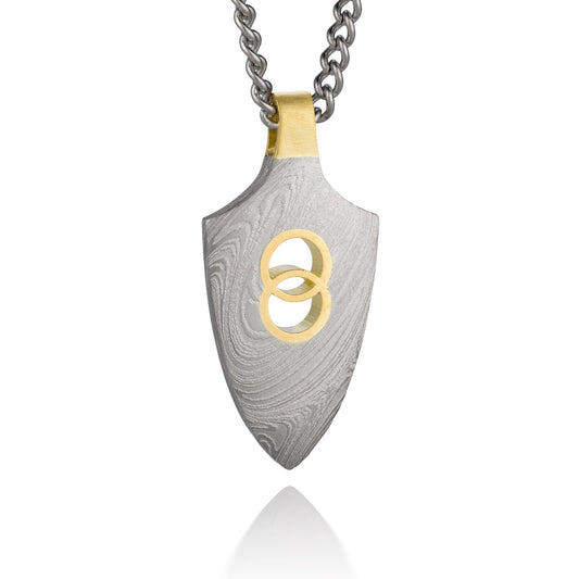 Silver shield-shaped Damascus necklace on a white background. 