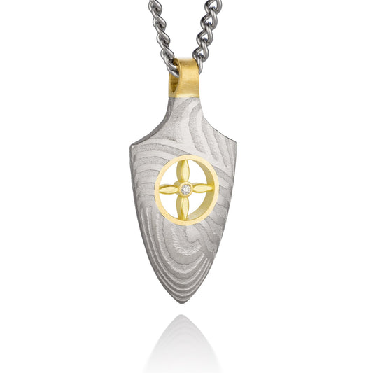 Silver shield-shaped Damascus necklace on a white background. 