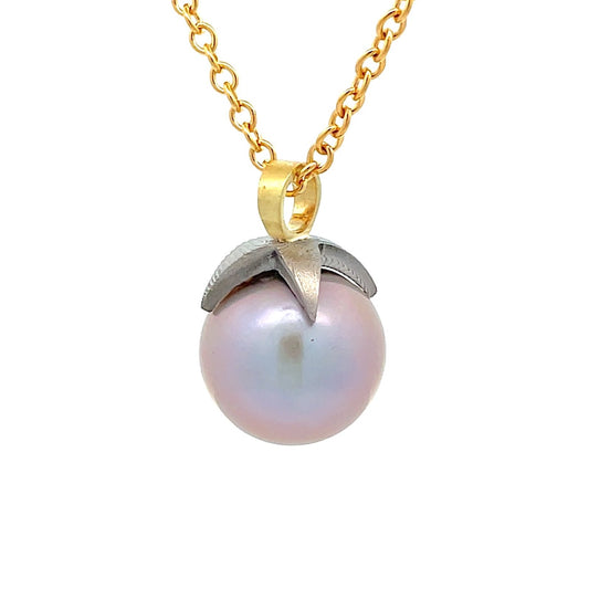 Gold chain necklace with a pink pearl pendant  on a white background.