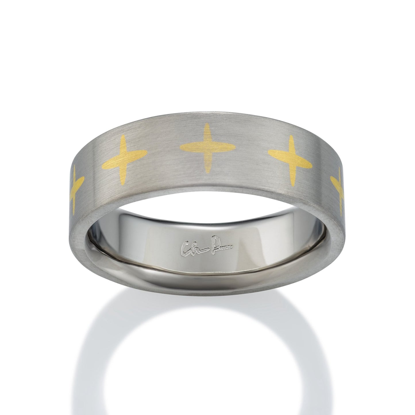 Two-tone silver and gold ring with a cross pattern on a white background