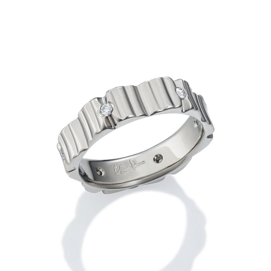 Silver ring with a textured, wavy pattern and diamond accents on a white background.