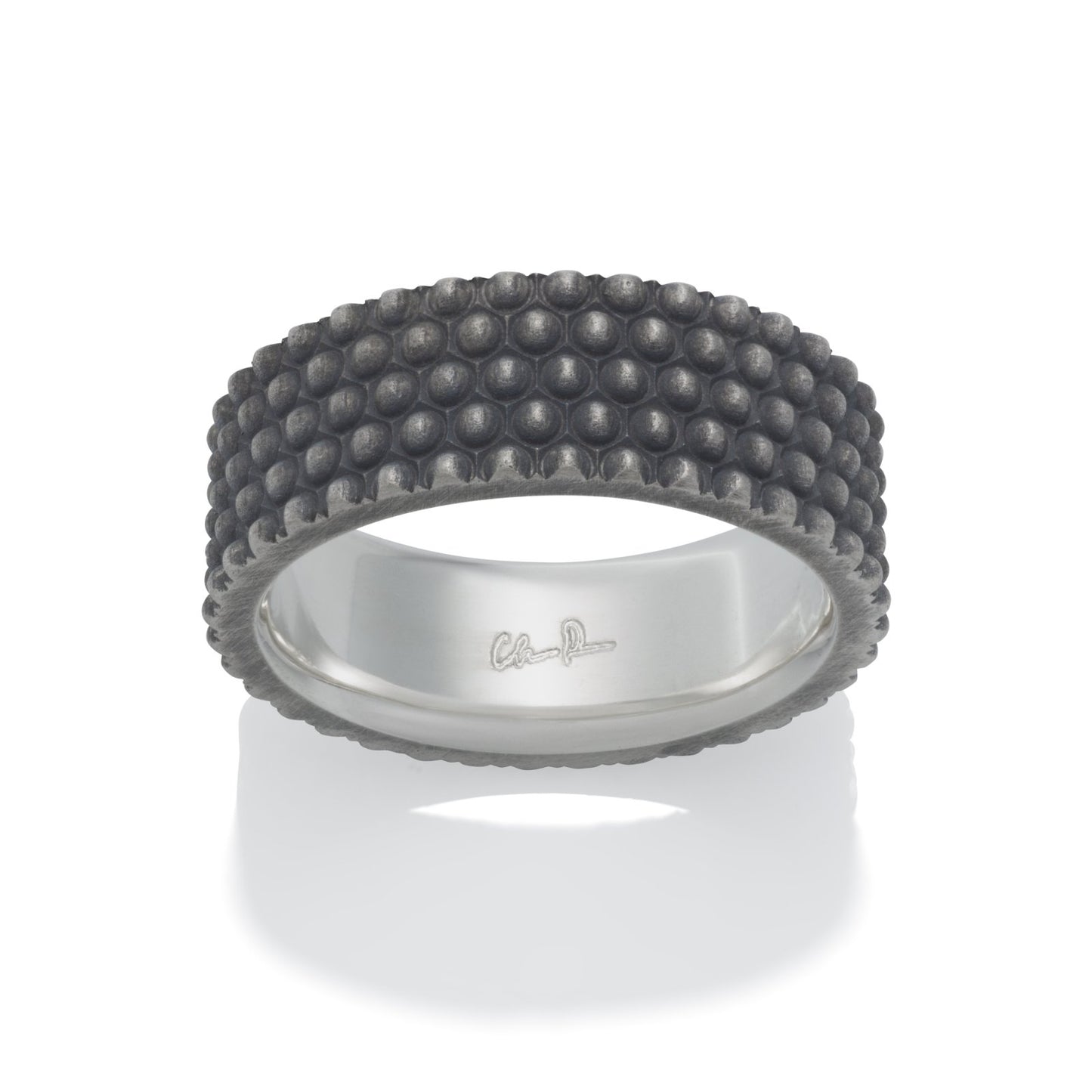 Silver ring with a textured, bumpy pattern on a white background.