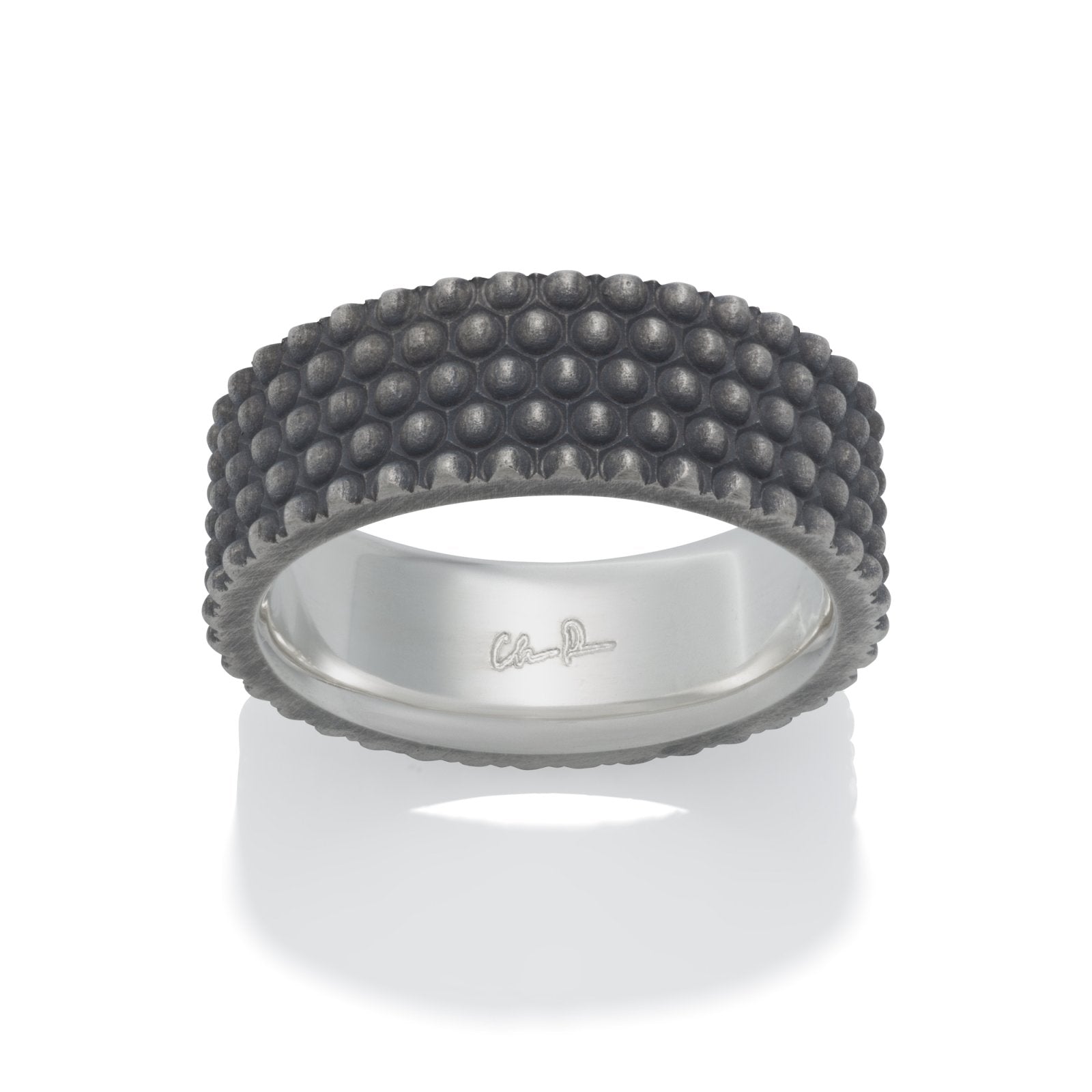 Silver ring with a textured, bumpy pattern on a white background.