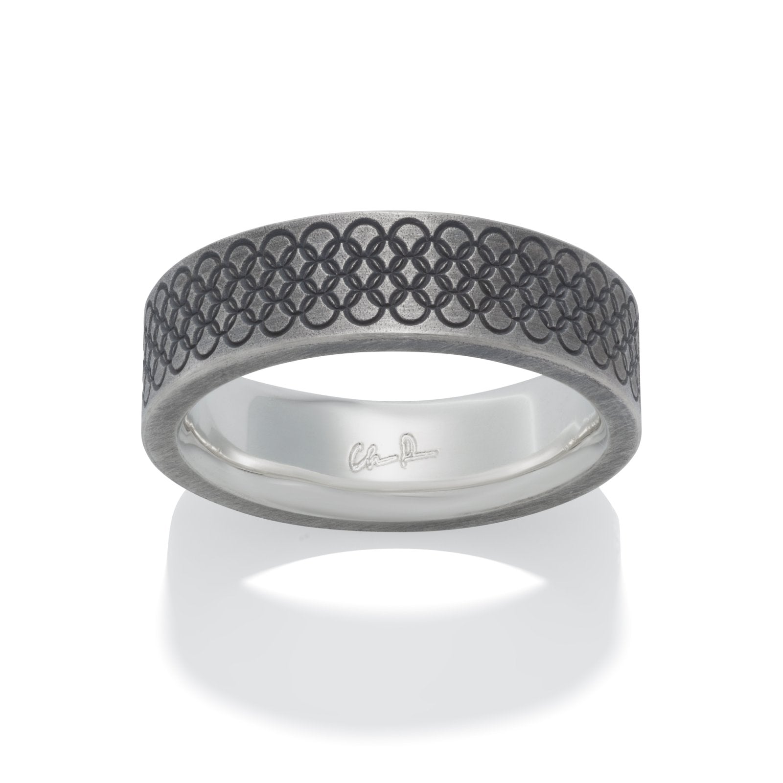 Silver ring with a textured, geometric pattern on a white background