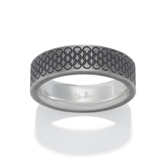 Silver ring with a textured, geometric pattern on a white background