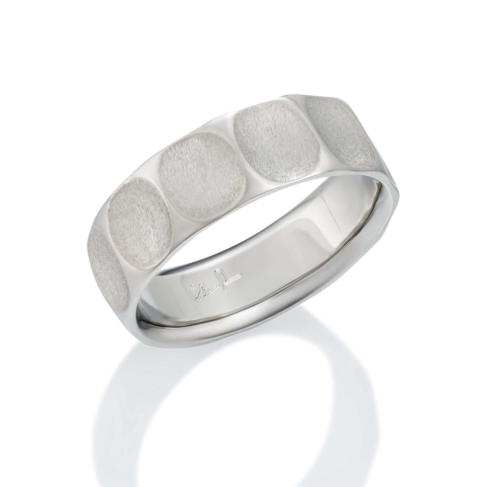 Silver ring with a textured, geometric pattern on a white background