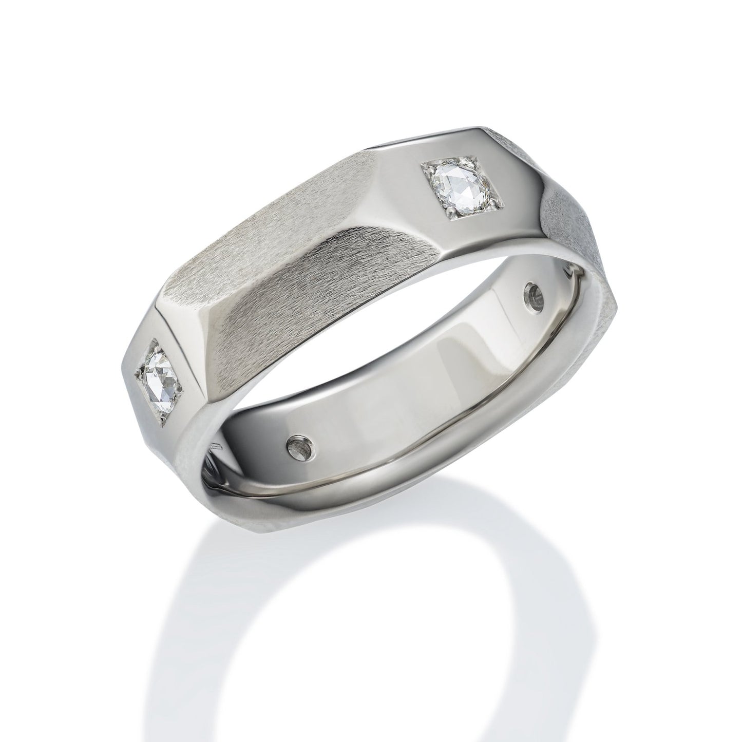 Silver ring with a geometric, faceted design and diamond accents on a white background.