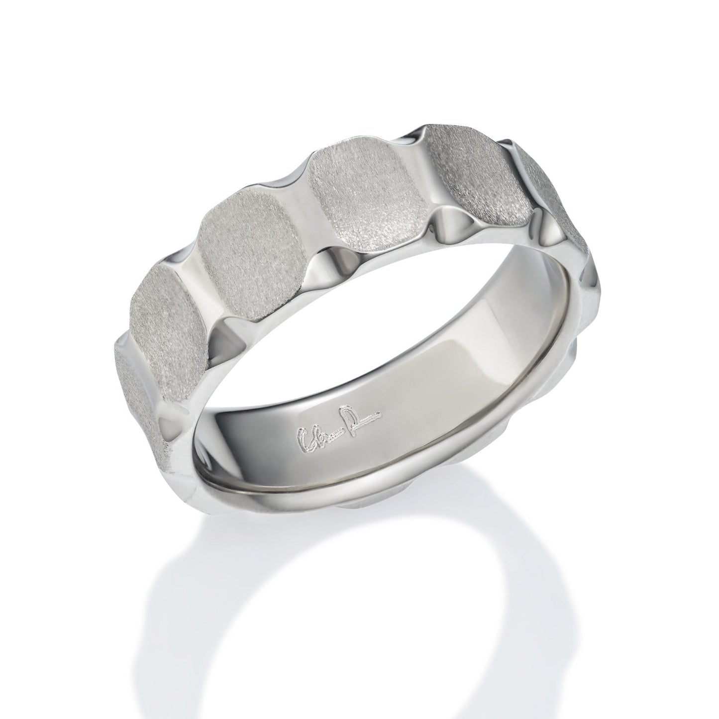 Silver ring with a geometric pattern on a white background