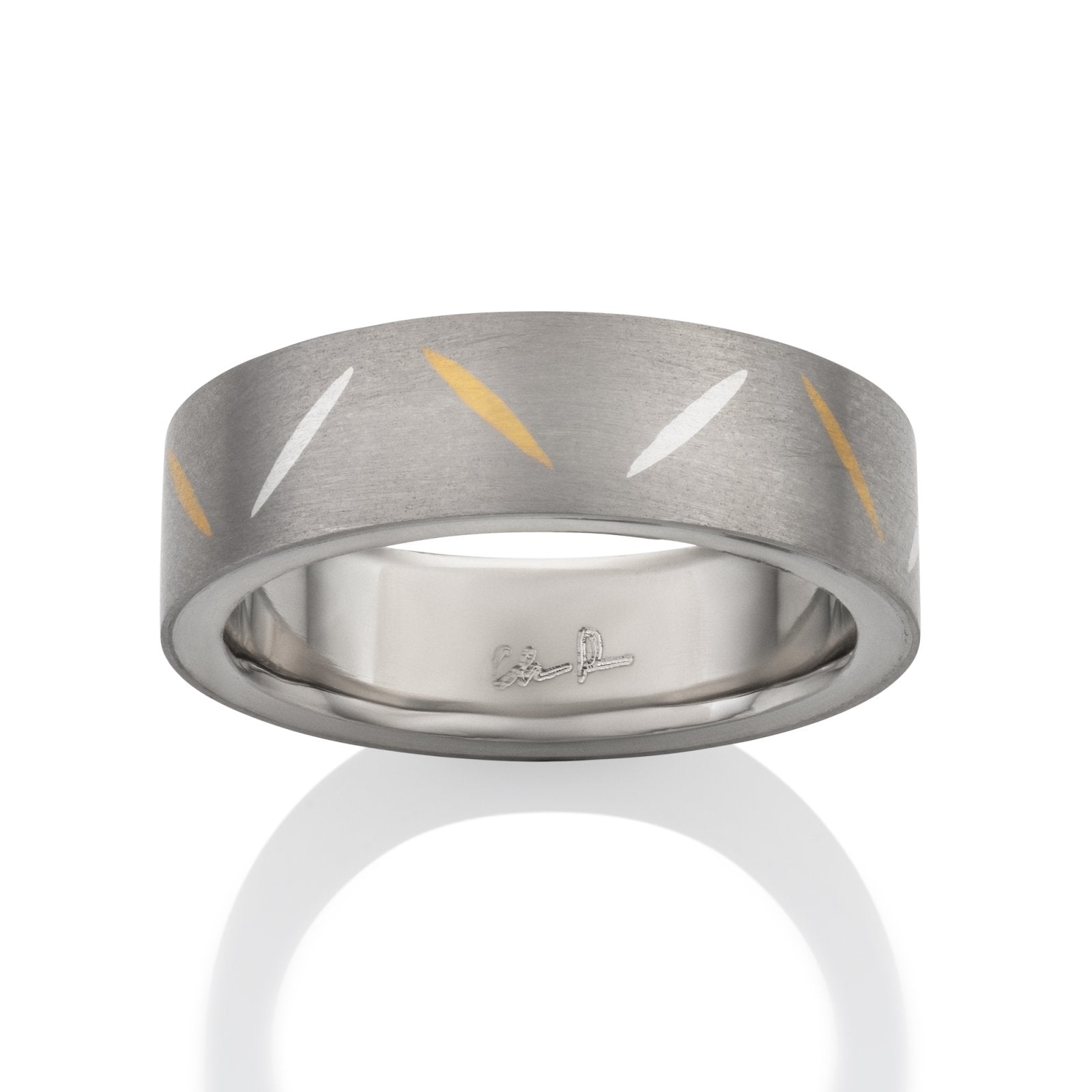 Two-tone tiatanium wedding band with a  yellow gold inlay on a white background