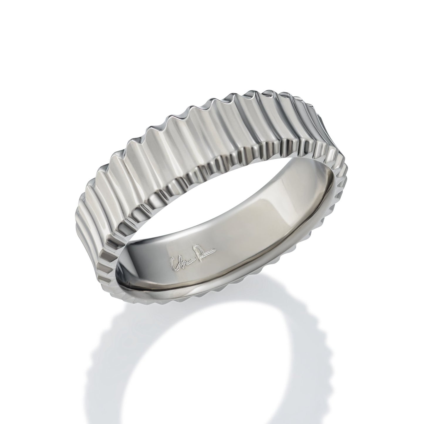 Silver ring with a textured, ribbed pattern, on a white background.