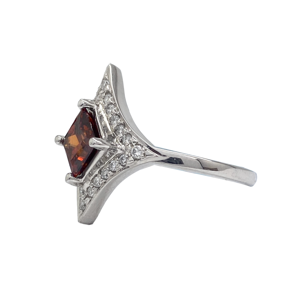 Silver ring with a large, square-cut garnet in the center. 