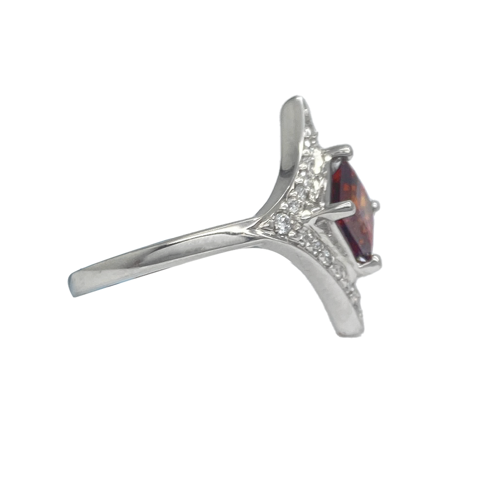 Side view of silver ring with a large, square-cut garnet in the center. 